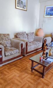 a living room with two couches and a coffee table at Residencia Isidora - Casa de Playa in Punta Hermosa