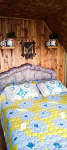 una cama con un edredón colorido en una habitación en Cabañas don Vicente, en Dalcahue