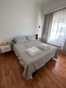 a bedroom with a bed with two towels on it at CASA EN LA FELIZ - pet friendly in Mar del Plata