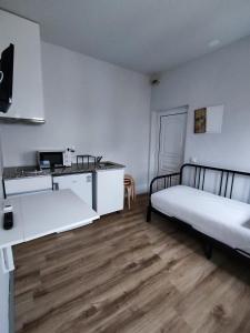 um quarto branco com 2 camas e uma cozinha em Vila dos Avós na Figueira da Foz