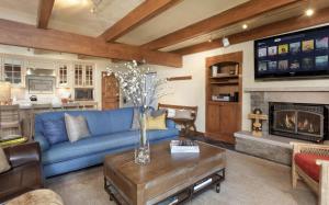 a living room with a blue couch and a fireplace at Timberline Condominiums 2 Bedroom Premier Unit C1D in Snowmass Village