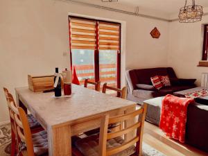 a living room with a table and a couch at Villa "Pahulja" - Vlašić in Vlasic +75 photos