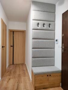 a room with a staircase with a bench and a door at Apartament 8 Piętro self check-in, parking in Rzeszów
