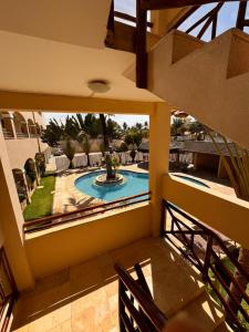 a view from the balcony of a house with a swimming pool at Cumbuco Paradise Beach Apartment in Cumbuco