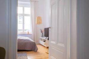 1 dormitorio con 1 cama y escritorio con TV en Design Altbautraum Wuppertal en Wuppertal