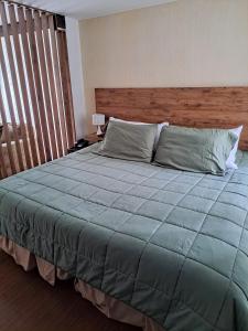 Ένα ή περισσότερα κρεβάτια σε δωμάτιο στο Acogedor Apartasuite cerca al Parque de la 93