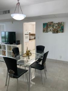 a dining room with a glass table and chairs at 14#Stunning Beach Apt - Miami Te Espera- HOLLYWOOD in Hollywood