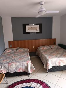 a bedroom with two beds and a basketball hoop on the wall at Condominio Residencial Thermas Place in Caldas Novas