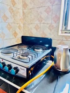 a stove top oven sitting on top of a counter at The cape vills in Kampala