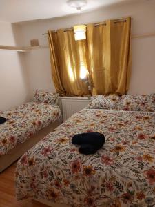 a bedroom with two beds with a pillow on it at Catford Homely Home in Hither Green