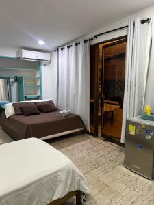 a bedroom with a bed and a sliding glass door at Apartaestudios norte de barranquilla in Barranquilla