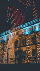 a christmas tree in front of a building with lights at Apart Otel Orbi City in Batumi