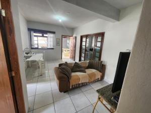 a living room with a couch and a table at Residencial Silveira in Itajaí