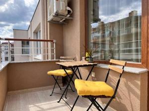 a balcony with a table and chairs on a balcony at Seaside apartment Tyndzha in Pomorie