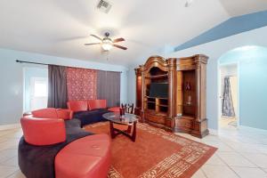 sala de estar con sofá y TV en Pastel Palms, en Lehigh Acres