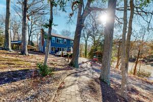 a blue house in the middle of the woods at Harbor House in Lusby