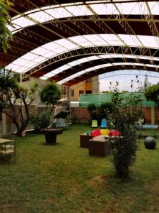 a patio with tables and couches in a yard at Hotel Cortaderas Arequipa in Yanahuara