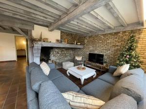 a living room with a large couch and a christmas tree at Villa James in Koksijde