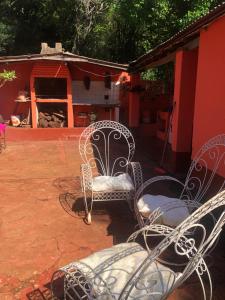 a group of chairs sitting on a patio at HOSPEDAJE PRÓCERES DE MAYO in Encarnación