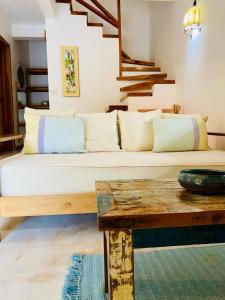 a living room with a couch and a table at Villas Argan - Paradise Gateway in Santa Teresa Beach