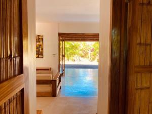 a hallway with a door leading to a swimming pool at Villas Argan - Paradise Gateway in Santa Teresa Beach