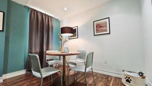 a dining room with a table and chairs at The Lofts on Clematis 505 Downtown West Palm Beach in West Palm Beach