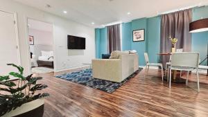 a living room with a couch and a table at The Lofts on Clematis 505 Downtown West Palm Beach in West Palm Beach