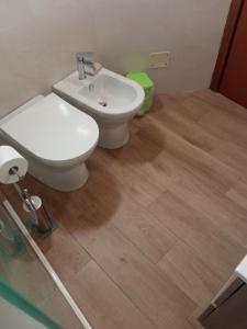 a bathroom with a toilet and a sink at ToviMar Apartments in Taormina