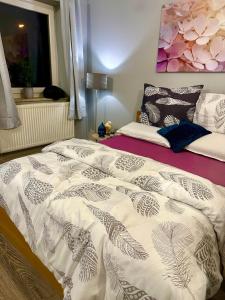 a bedroom with a bed with a white comforter at Wohnung in Zentrum Köln in Cologne