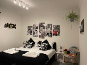 a bedroom with a bed with black and white pillows at Central Blue Holiday Home. in Bridlington