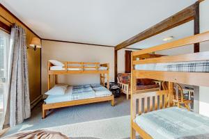 a bedroom with two bunk beds and a bed at Alpine Horn Lodge at Big Powderhorn Mountain in Ironwood