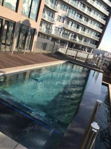 a large swimming pool in front of a building at Modern Exec 2Bed Apartment at Infinite in Johannesburg