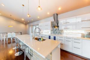 a kitchen with white cabinets and a large island at Spokane River Retreat in Coeur d'Alene