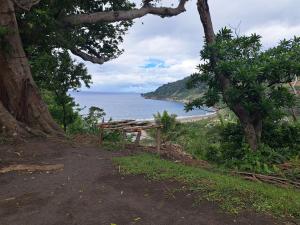a picnic table on a hill next to the ocean at Appartement de Charles in Loméméti