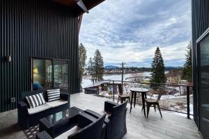 a patio with a table and chairs on a balcony at Spokane River Retreat in Coeur d'Alene