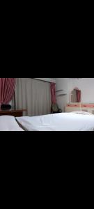 two beds in a bedroom with pink curtains at تراس سموحه - بيتك يطل علي نادي سموحه in Alexandria