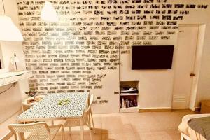 a living room with a table and a wall covered in writing at White beach Boracay Apartment A9 in Boracay