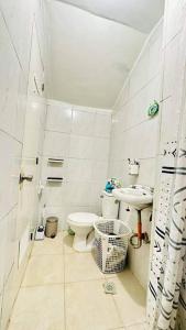 a white bathroom with a toilet and a sink at White beach Boracay Apartment A9 in Boracay
