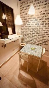 a table and chair in a room with a brick wall at White beach Boracay Apartment A9 in Boracay