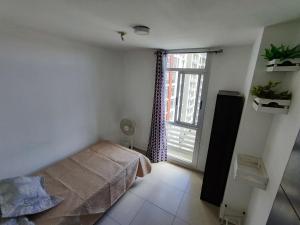 a bedroom with a bed and a large window at Cute apartment 5min from the airport in Salsipuedes
