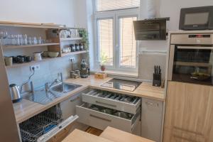 a kitchen with a sink and a counter top at Old Town's Legend: City center condo with balcony in Maribor
