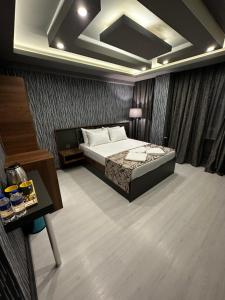 a bedroom with a bed and a desk and a bed sidx sidx sidx at Loft Suite Residence in Bursa