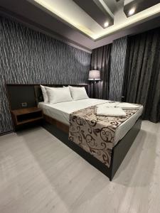 a bedroom with a bed and a television in it at Loft Suite Residence in Bursa