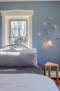 a blue bedroom with a bed and a window at The Tannery in Lancaster