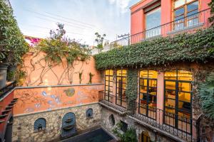 a building with ivy on the side of it at Casa Almira 5BR Luxury Home with Pool, Hot Tub & Rooftop in San Miguel de Allende