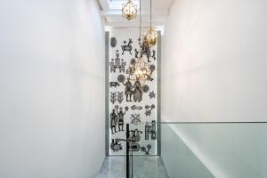 a hallway with a wall covered in stickers at Casa Spada Rooms in Cagliari