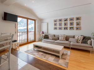 a living room with a couch and a table at Chalet Mountain View in Alpbach