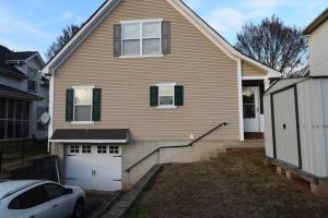a house with a car parked in front of it at Home In Greenville 4 bedrooms, 4 beds, 2 baths in Greenville