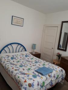 a bedroom with a bed with a comforter on it at Pleasant Rooming House in Washington