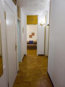 a hallway with white doors and tile floors at Bike house 5 "classic" in Seriate